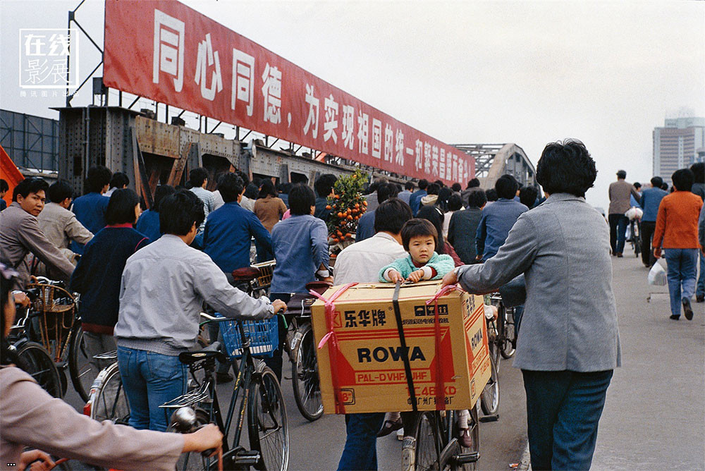 1980s. In the early 80s, the first televisions begin to enter Chinese homes. The image shows a TV color set just bought while being transported in some way at home..jpg